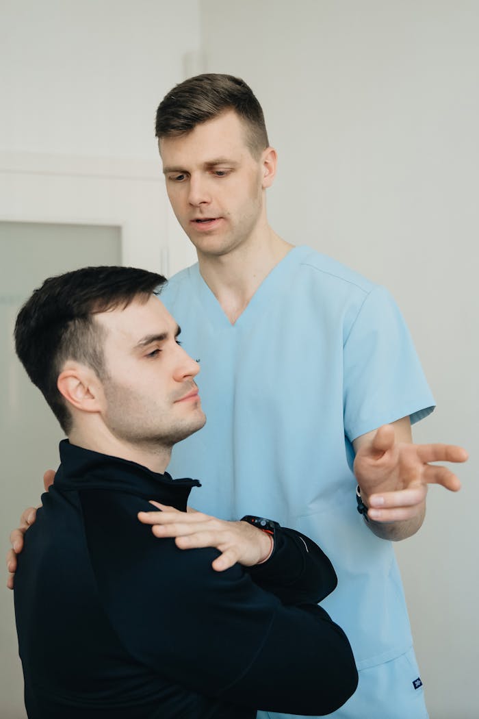 A physiotherapist assists a patient during a therapy session indoors.